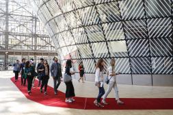 Visitors walking around the lantern-shaped metal structure in the Europa building.