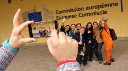 Person taking picture of group of people in front of European Commission