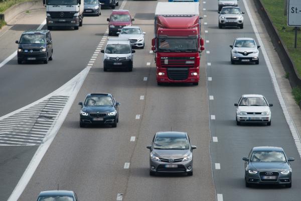 Busses, commercial vehicles, vans and lorries driving on a motorway