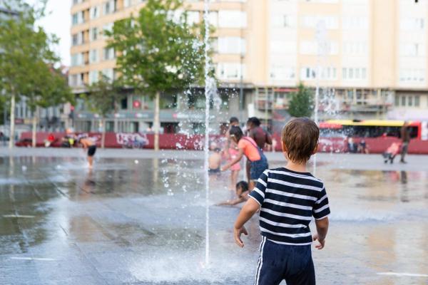 A child playing in water jets 