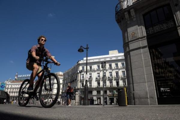 A young man riding his bike in Madrid city centre
