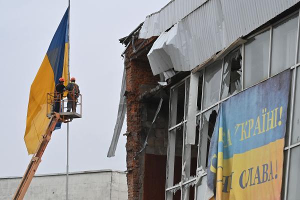 People working on an Ukranian broken building