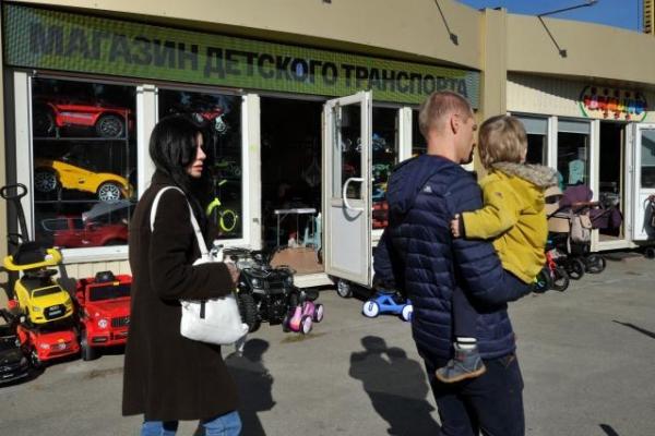 A family walking past a children's shop in Kyiv