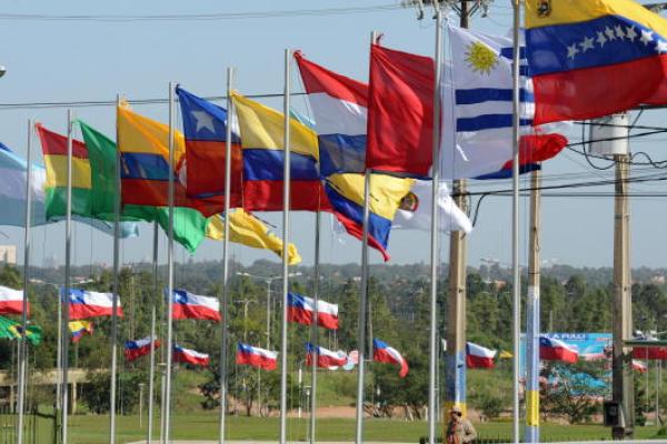 Row of flag masts flying the flags of Latin America and the Caribbean