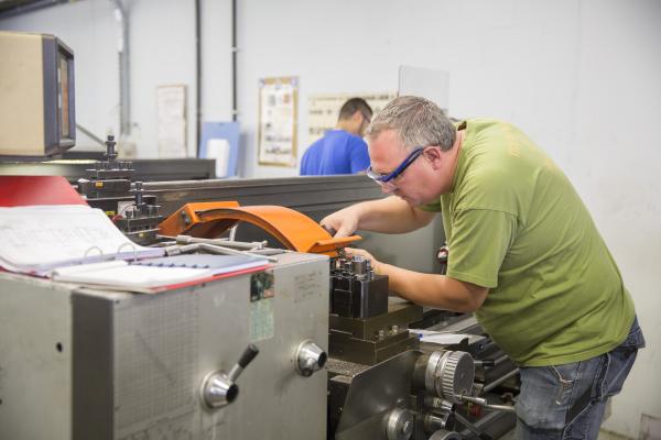 Jobseekers - men - being trained on numerical machines