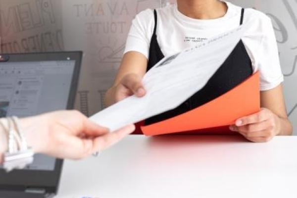 Women giving in documents