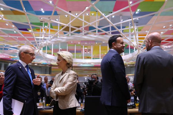 Four EU leaders stand talking at the European Council meeting in Brussels on 27 October