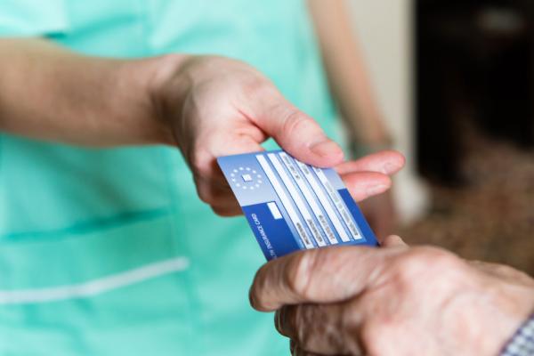 A person holding the European Health Insurance Card