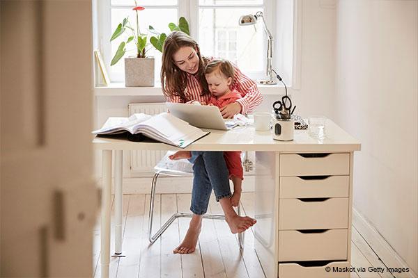 Mother sitting with daughter paying bills