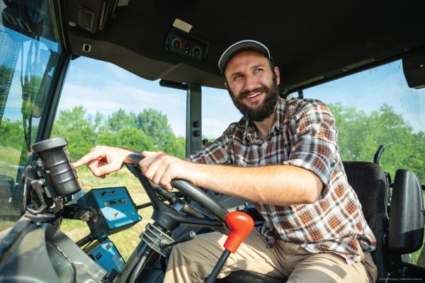 Smiling farmer in his tractor