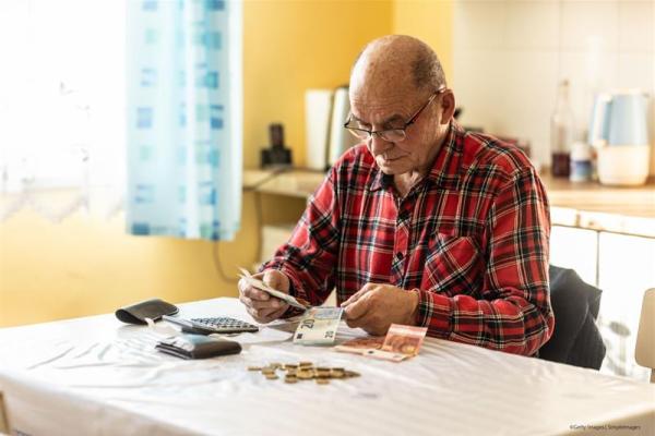 Close-up of a senior man counting money in European Union currency