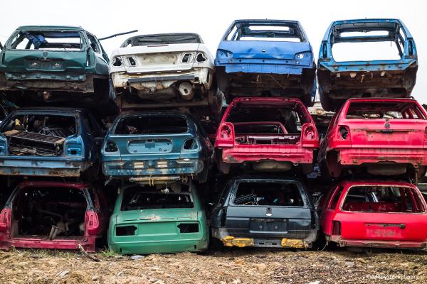Scrap cars piled up in a junkyard