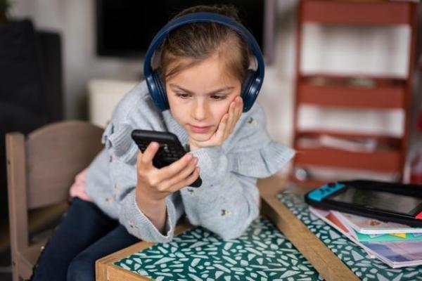 Young girl looking at her smartphone