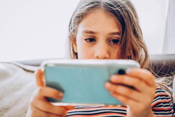 Young girl staring at her smartphone
