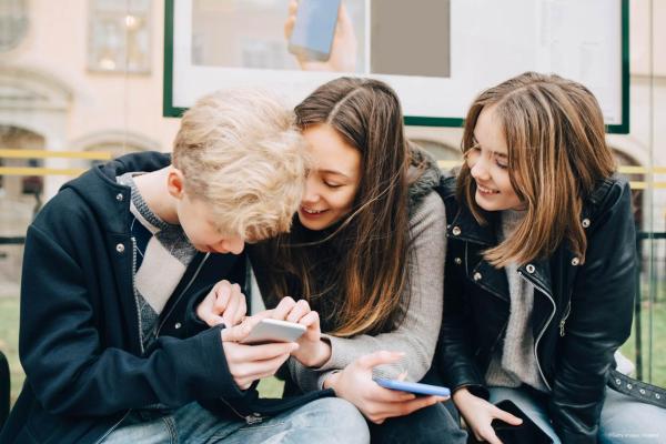 Kids staring at phone screen