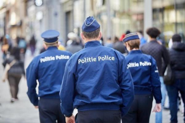 Three Belgian policemen viewed from behind
