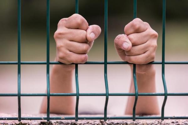 Hands behind bars