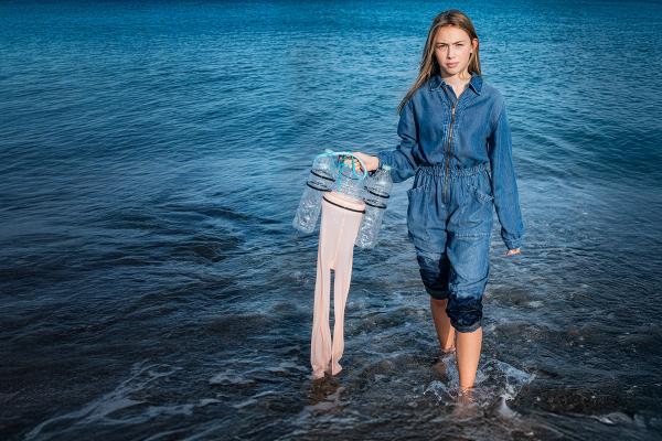 Olivia Mandle standing in the sea holding a Jelly Cleaner